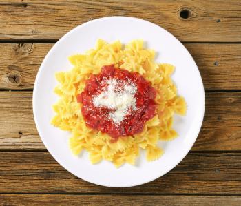 Bow-tie pasta with thick tomato sauce and parmesan