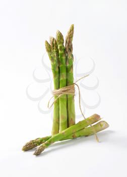 Bundle of fresh asparagus on white background
