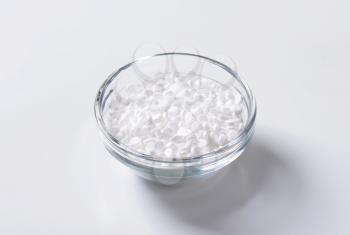 Artificial sweetener tablets in glass bowl