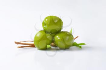 Fresh green olives on white background