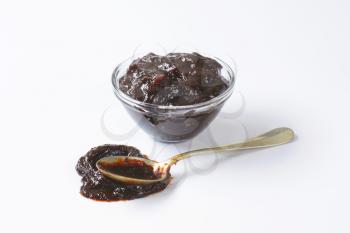 Bowl and spoon of plum preserve
