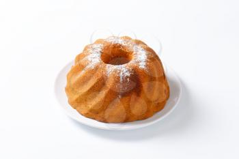 Chocolate and vanilla bundt cake sprinkled with icing sugar