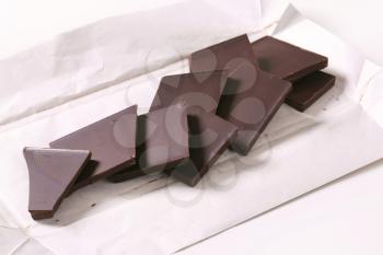 Pieces of plain chocolate on wrapper