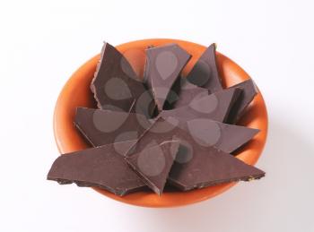 Pieces of dark chocolate in a bowl