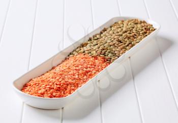 Raw red and brown lentils in a long dish