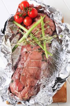Beef tenderloin with thyme in tinfoil