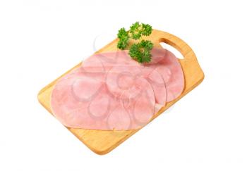 Thinly sliced ham on cutting board