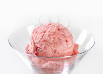 Scoop of strawberry ice cream  in stemmed glass