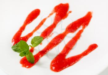 Strawberry drizzle sauce on plate