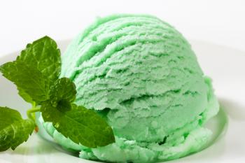 Scoop of green ice cream on plate