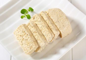 Slices of homemade tofu on plate