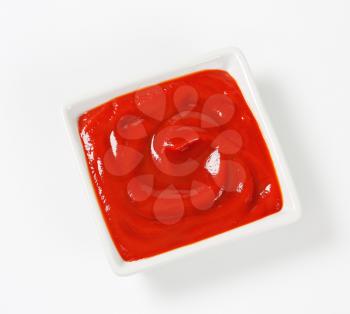 Smooth tomato passata in a small square dish