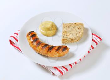 Grilled bratwurst with bread and mustard