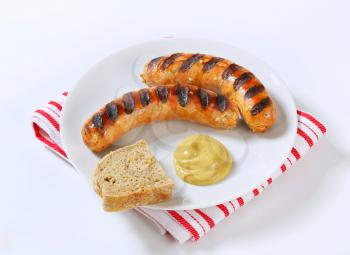 Grilled bratwursts with bread and mustard