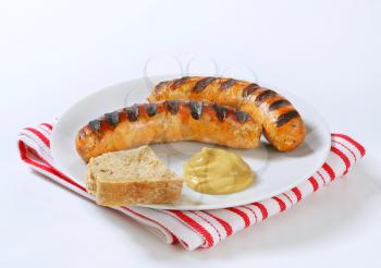 Grilled bratwursts with bread and mustard