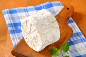 French Chaource cheese on cutting board