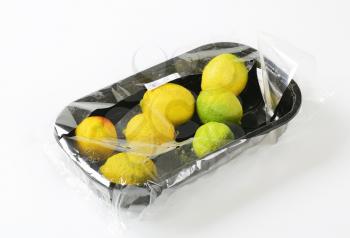 Fresh lemons in plastic packaging