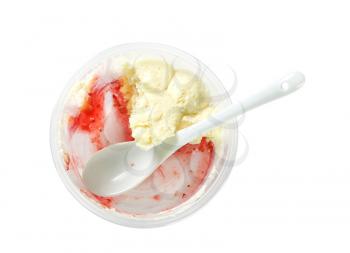 Half-eaten strawberry shortcake dessert in plastic cup