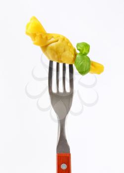 Caramelle-shaped stuffed pasta on fork
