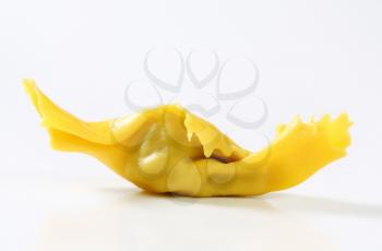 Caramelle-shaped stuffed pasta on white background