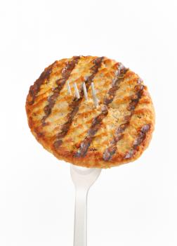 Grilled patty on a fork