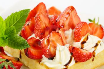 Belgian waffle with whipped cream and fresh strawberries