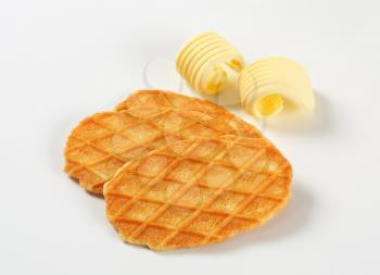 Thin waffle crisps and curls of fresh butter