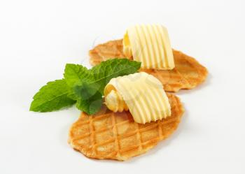 Thin waffle crisps and curls of fresh butter