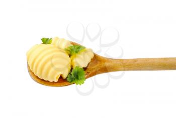 Butter curls on wooden spoon