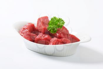 Raw diced beef in a  porcelain bowl