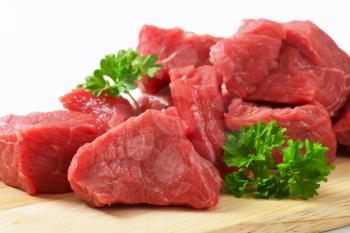 Raw diced beef on cutting board