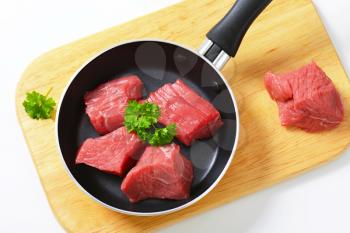 Raw diced beef in a pan