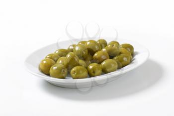 Fresh green olives on plate