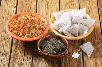 Dried jasmine leaves and flowers and pyramid tea bags
