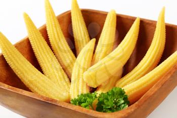 Dish of pickled baby corn cobs