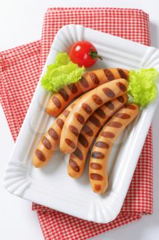 Grilled Vienna sausages  on white porcelain plate