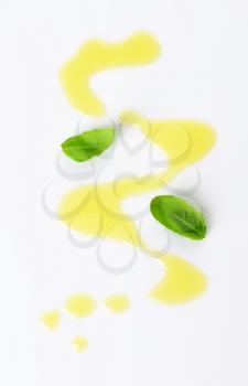 Olive oil drizzle and fresh basil leaves
