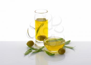 Olive oil in tall glass mug and bowl