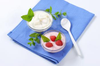 Light raspberry and white yogurt in glass bowls