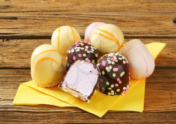 Assorted marshmallow treats on yellow napkin