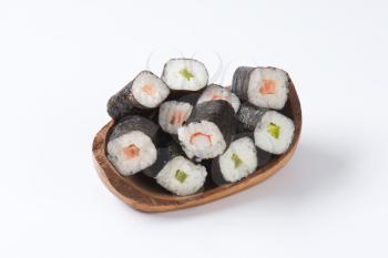 Maki sushi rolls with salmon, crab and cucumber inside
