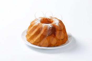 Chocolate and vanilla bundt cake sprinkled with icing sugar