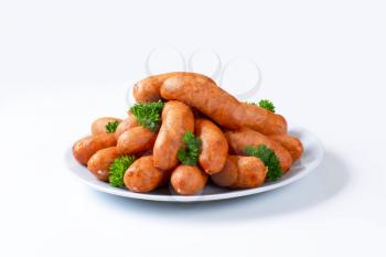 Pile of short kielbasa sausages on plate