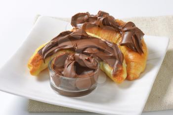 croissants topped with chocolate butter spread
