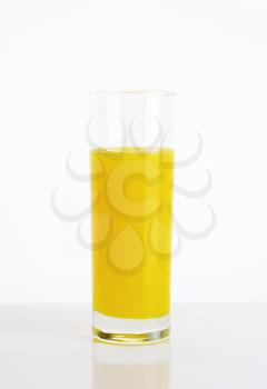 Yellow lemon juice drink served in tall glass