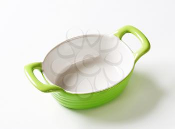 Empty green ceramic baking dish