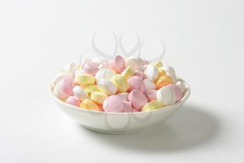 Lentil-shaped fruit flavor candy in soft pastel colors
