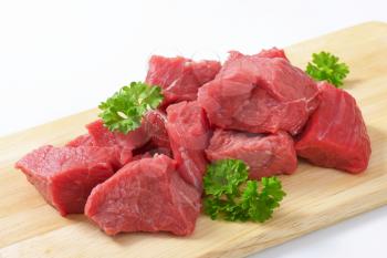 Raw diced beef on cutting board