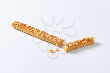 Puff-pastry strips with cheese topping