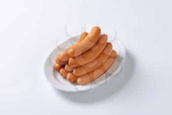 Pile of Vienna sausages on plate